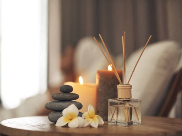 Spa setting with hot stones, candle and diffuser